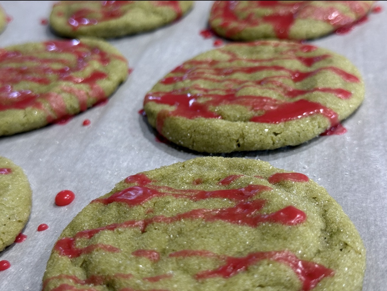 Matcha cookie drizzled with raspberry glaze